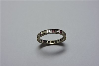 Lot 12 - A white gold ruby and diamond eternity ring