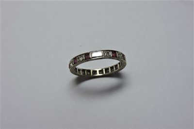 Lot 12 - A white gold ruby and diamond eternity ring