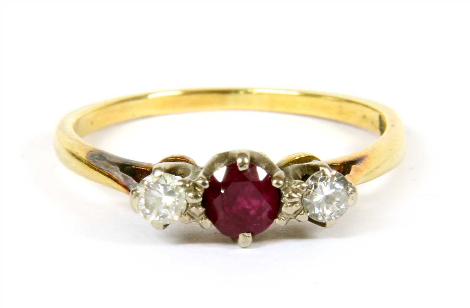 Lot 27 - A three stone ruby and diamond ring