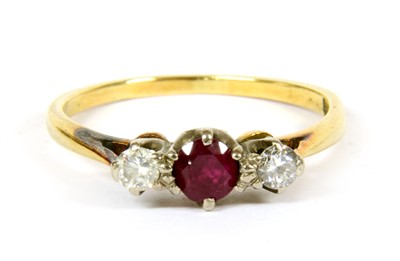Lot 27 - A three stone ruby and diamond ring