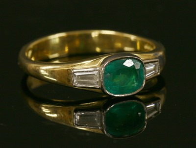 Lot 342 - An 18ct gold emerald and diamond three stone ring