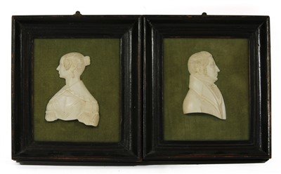 Lot 162 - A pair of 19th Century Dieppe ivory profile portraits depicting man and woman