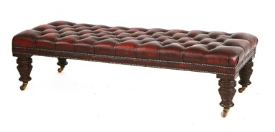 Lot 900 - A large button upholstered leather footstool