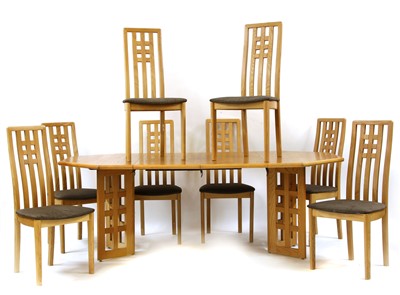 Lot 637 - A modern oak extending dining table and eight chairs