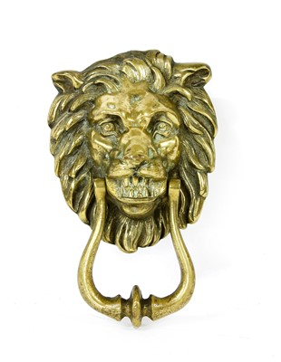 Lot 142 - A brass door knocker in the form of a lion mask