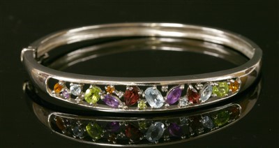 Lot 526 - A 9ct white gold gemstone and diamond hinged bangle