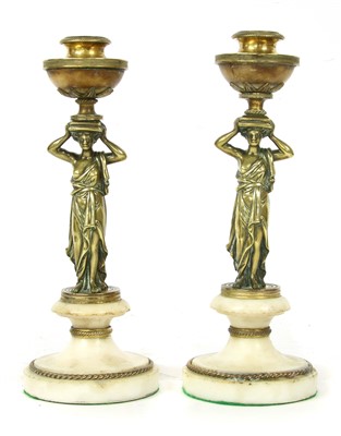 Lot 120 - A pair of figural candlesticks
