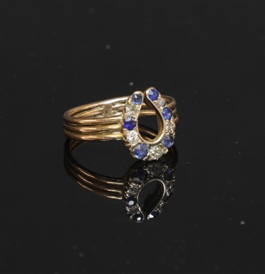 Lot 104 - A sapphire and diamond horseshoe ring
