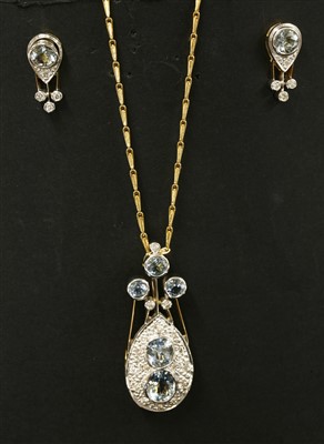 Lot 364 - An 18ct gold aquamarine and diamond pendant/brooch and earring suite, c.1980
