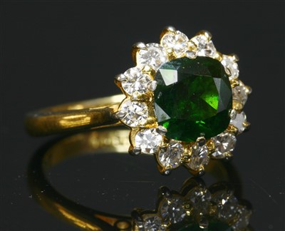 Lot 508 - A demantoid garnet and diamond cushion shaped cluster ring