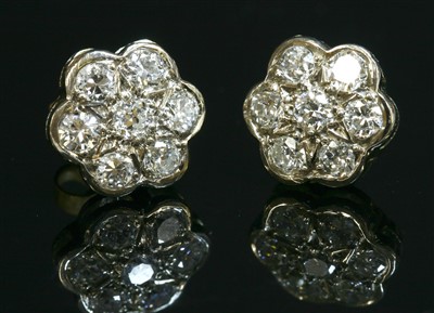 Lot 468 - A pair of white gold diamond set daisy cluster earrings