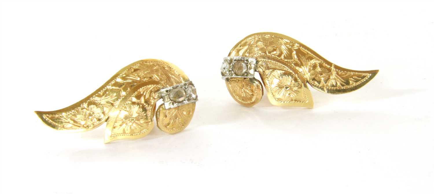 Lot 38 - A pair of gold and diamond vertical scroll earrings