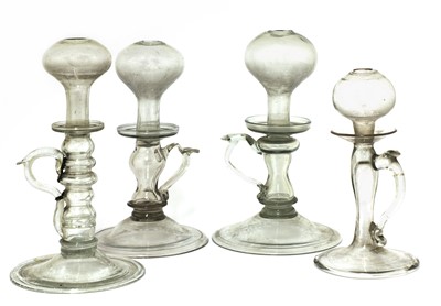 Lot 266 - A group of four open flame 'lacemaker' type glass oil lamps
