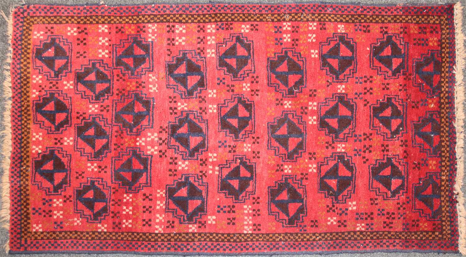 Lot 286 - A Bokhara type rug with rust coloured ground