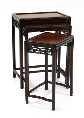 Lot 307 - A Chinese hardwood nest of three tables