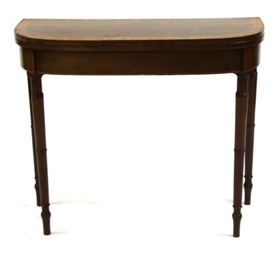 Lot 271 - A George III foldover card table standing on turned tapering legs