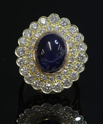 Lot 298 - An 18ct gold sapphire and diamond oval cluster ring