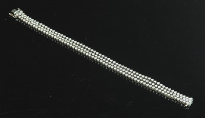 Lot 443 - A white gold three row diamond set line bracelet