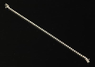 Lot 393 - An 18ct white gold diamond set line bracelet