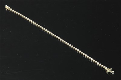 Lot 328 - An 18ct gold diamond set line bracelet