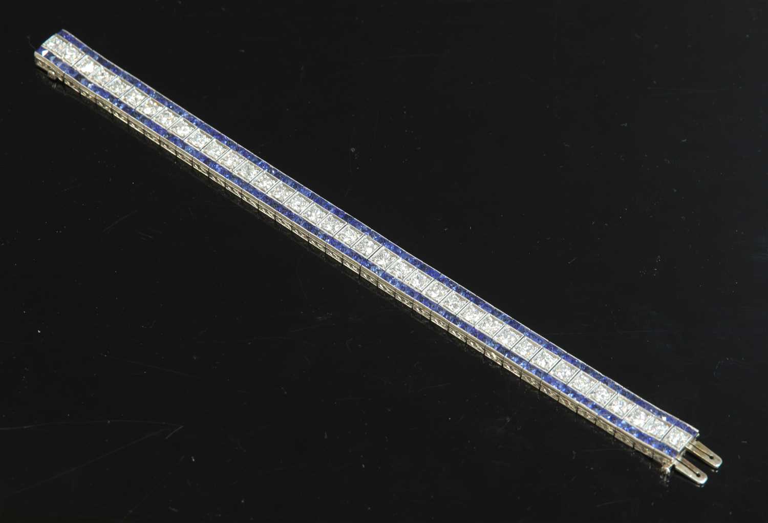 Lot 208 - An Art Deco platinum diamond and sapphire bracelet