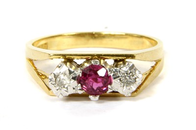 Lot 110 - A gold ruby and diamond three stone ring