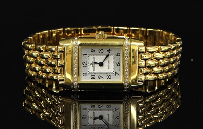 Lot 638 - A ladies' 18ct gold diamond set Jaeger-LeCoultre Reverso quartz bracelet watch