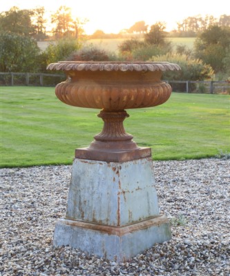 Lot 938 - A large Regency-style cast iron urn on stand