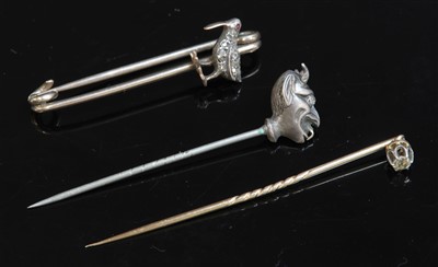 Lot 128 - A head of Satan silver and gold diamond set stick pin