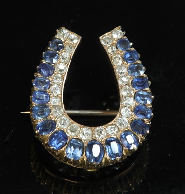 Lot 70 - A late Victorian sapphire and diamond horseshoe brooch