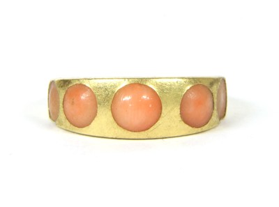 Lot 55 - An 18ct gold coral five stone ring