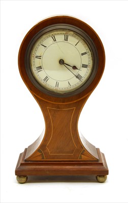 Lot 501 - An Edwardian strung and inlaid mahogany balloon mantel clock