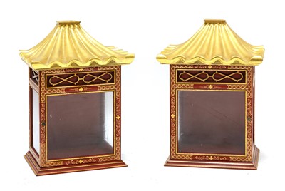 Lot 742 - A pair of red lacquered and gilt wall cabinets