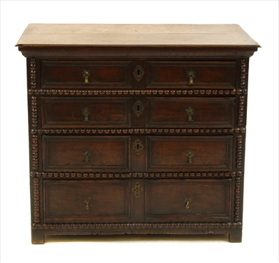 Lot 876 - An oak chest of four long drawers