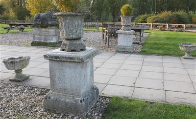 Lot 936 - A pair of composition stone urns