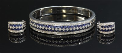 Lot 198 - A white gold sapphire and diamond hinged bangle and earring suite