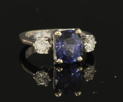 Lot 289 - An 18ct white gold three stone sapphire and diamond ring