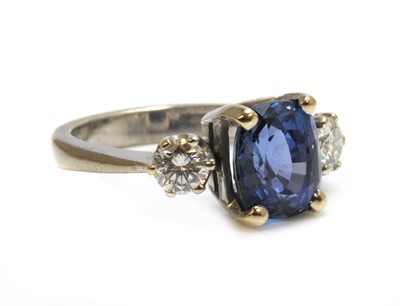 Lot 289 - An 18ct white gold three stone sapphire and diamond ring