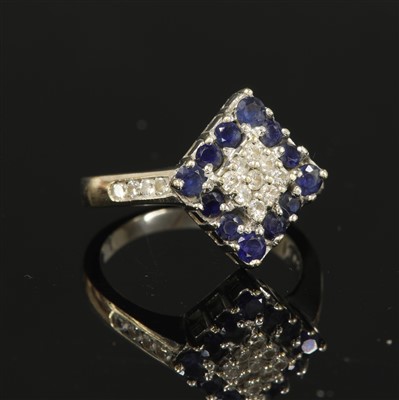 Lot 85 - A white gold diamond and sapphire lozenge-shaped cluster ring