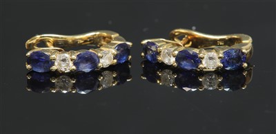 Lot 310 - A pair of 18ct gold sapphire and diamond half hoop earrings