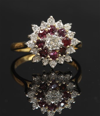Lot 303 - An 18ct gold diamond and ruby three-tier cluster ring