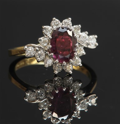Lot 262 - An 18ct gold ruby and diamond crossover cluster ring