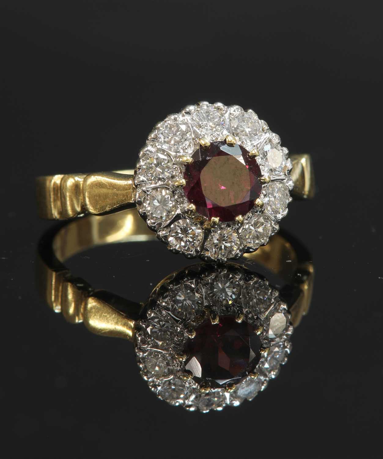 Lot 344 - An 18ct gold garnet and diamond circular cluster ring