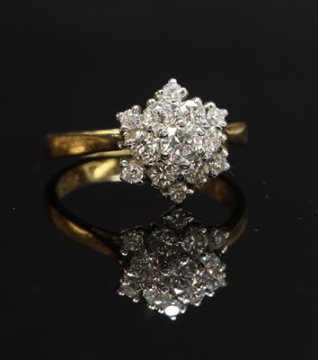 Lot 330 - A two colour gold diamond set snowflake cluster ring