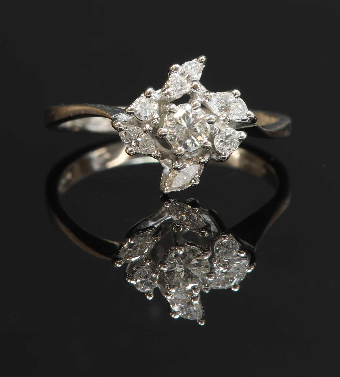 Lot 411 - An 18ct white gold diamond cluster crossover ring