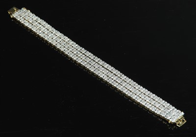 Lot 531 - An 18ct two colour gold three row diamond cluster bracelet