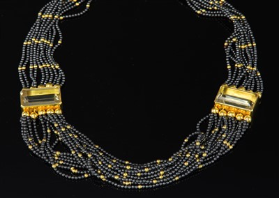Lot 350 - A sixteen row gold haematite and citrine swag or torsade necklace