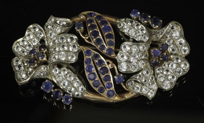 Lot 230 - A Continental gold and silver, blue and white sapphire oval form spray brooch