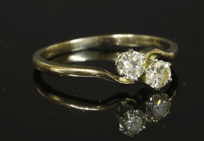 Lot 255 - A two stone crossover ring
