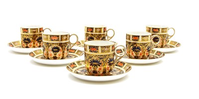 Lot 409 - A set of six Crown Derby Imari pattern coffee cups and saucers